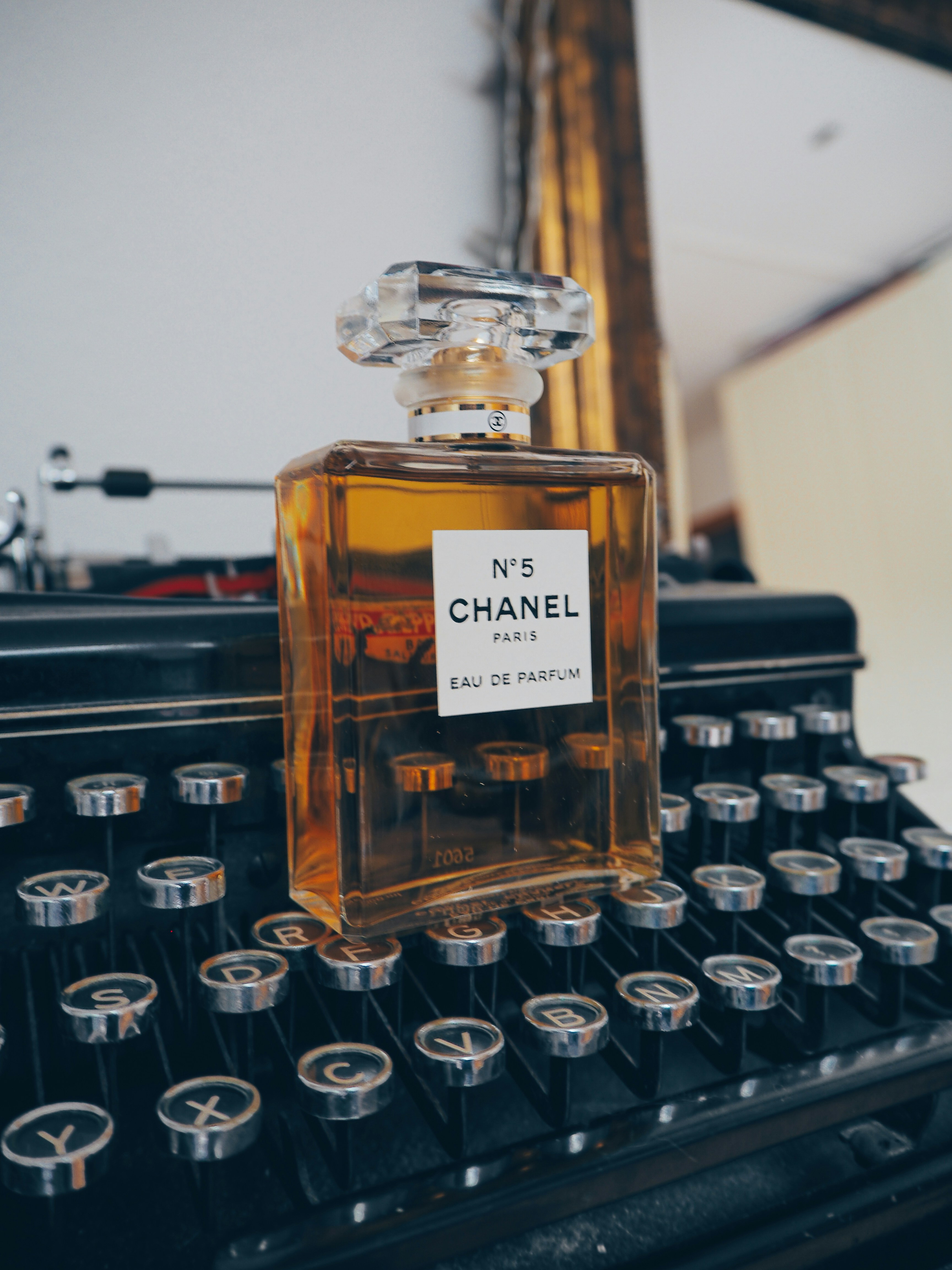 clear glass bottle on black typewriter