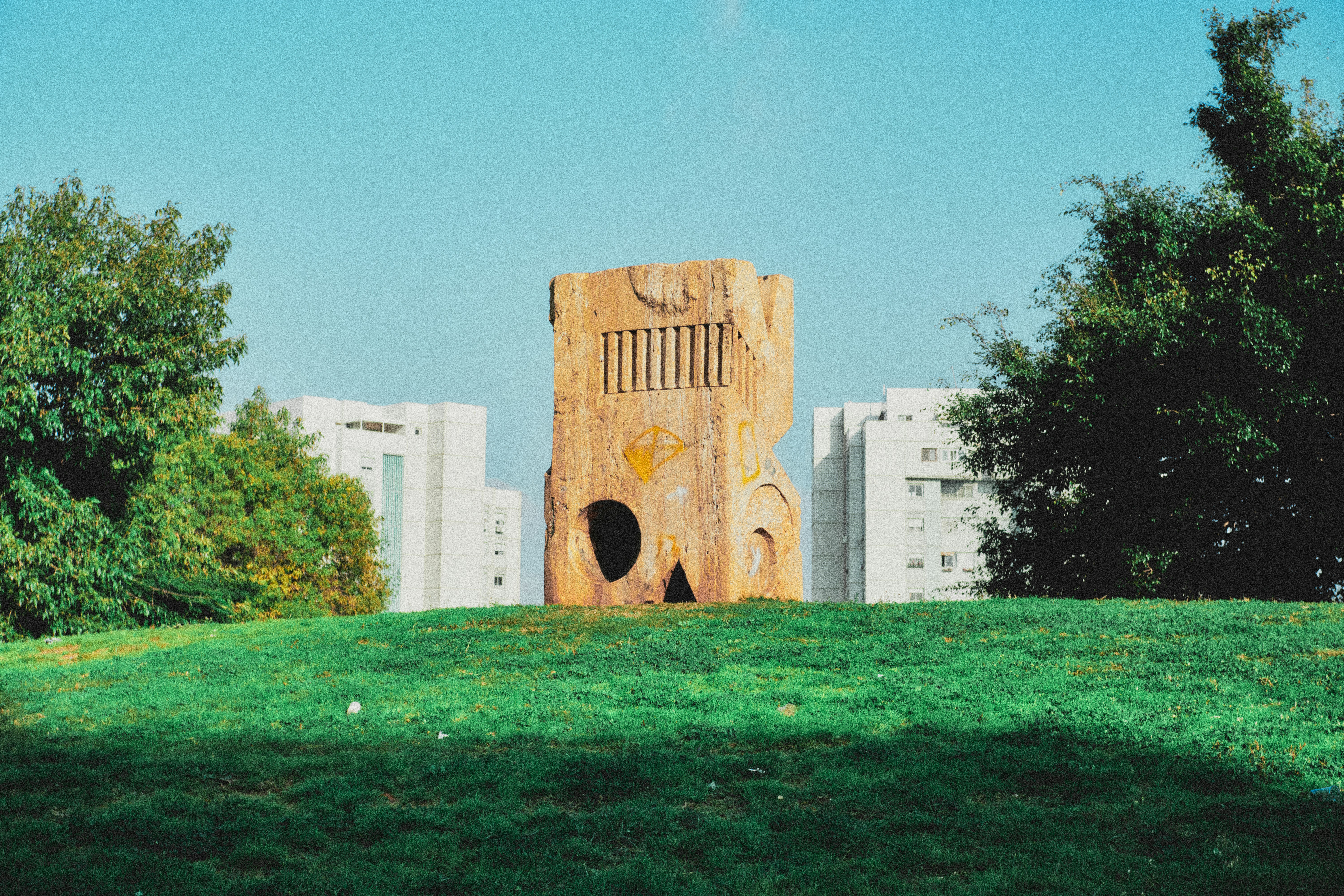 brown concrete building near green grass field during daytime