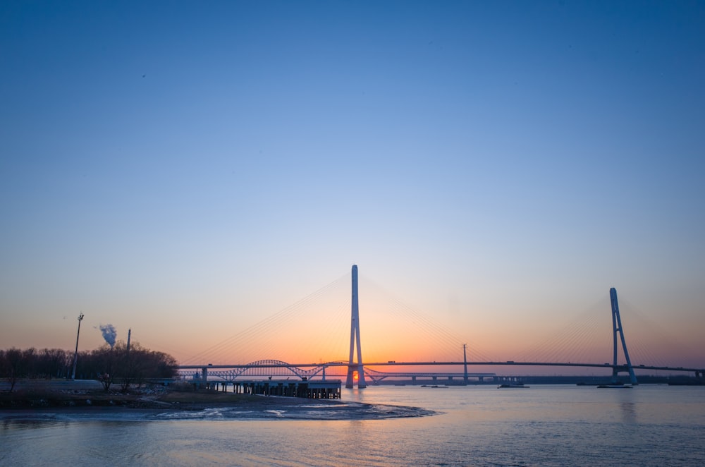 bridge over water during sunset