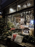 Cozy gift shop window display with handcrafted items and soft natural lighting.