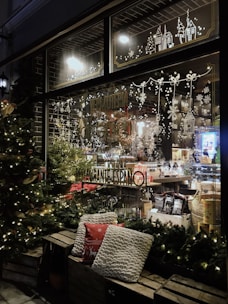 A beautifully decorated shop window with festive watercolor art.