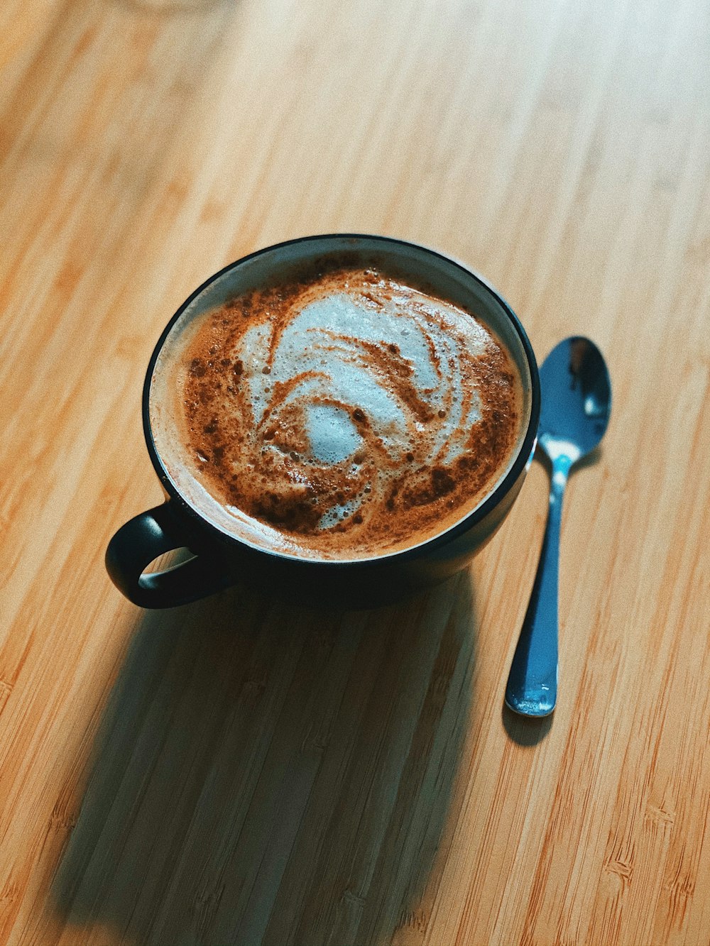 black ceramic mug with brown liquid