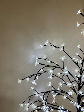 An imposing golden tree with sprawling branches glowing softly against a parchment background.