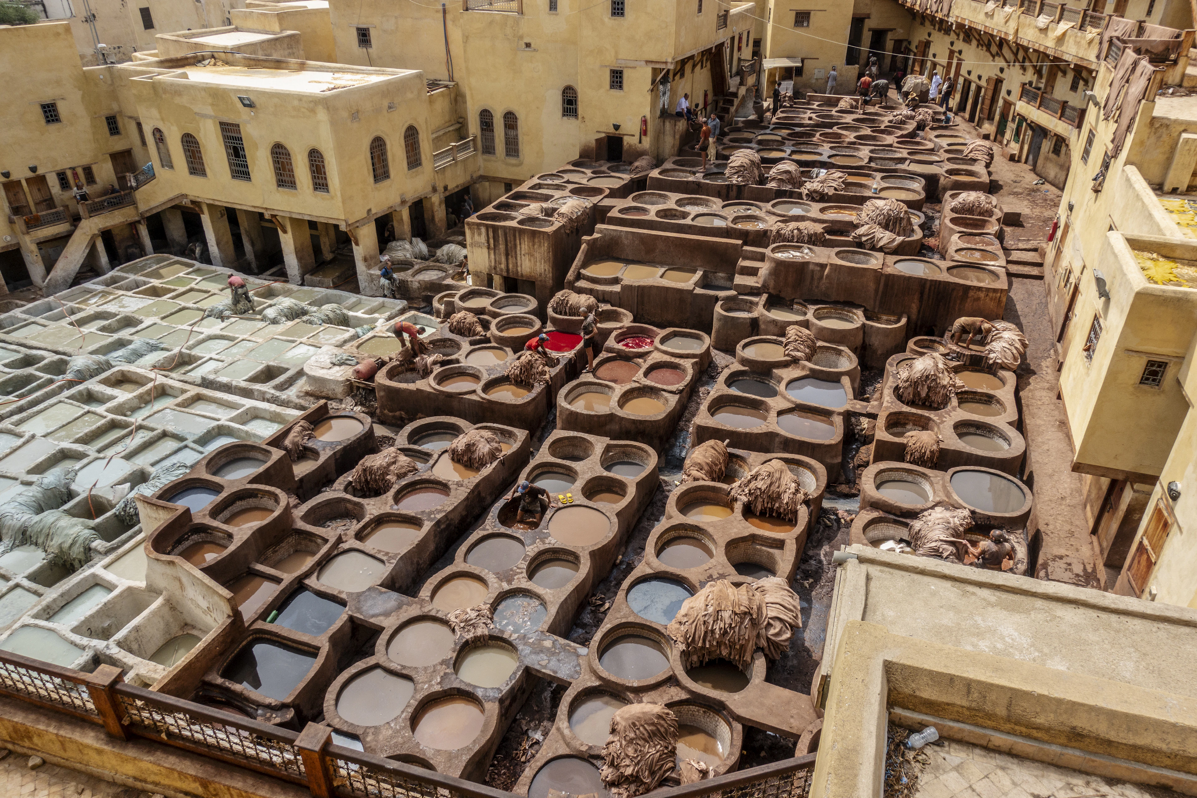 Aerial view of the Chouara Tannery's honeycomb of stone dye pits amid Fez's old city rooftops
