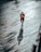 man in black jacket and black pants walking on wooden dock during daytime