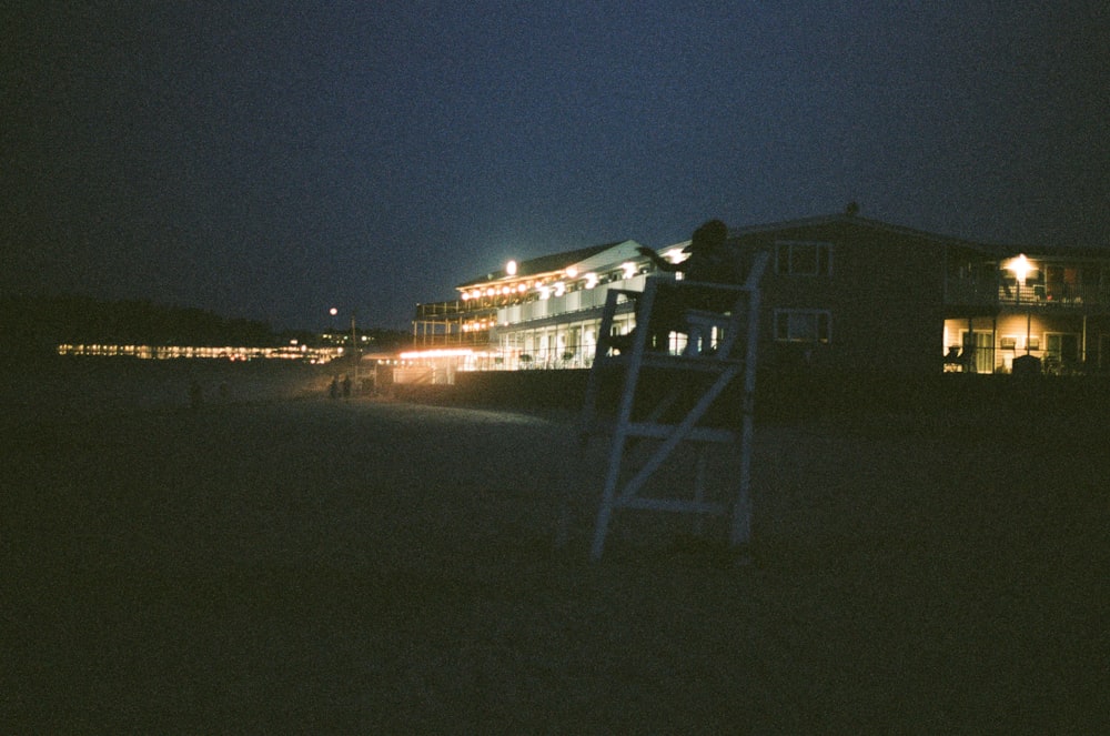 white wooden fence near body of water during night time