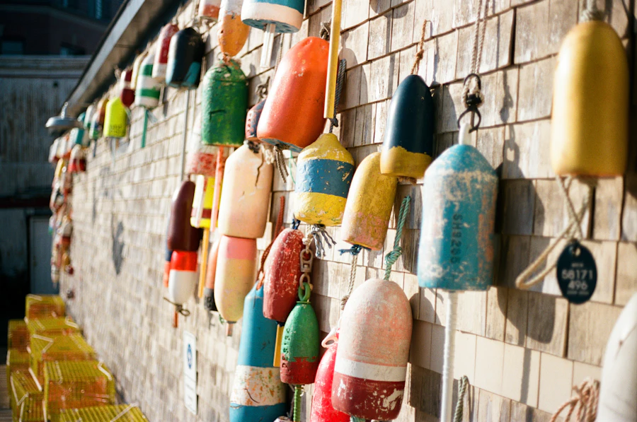 Colorful lobster buoys hanging on a shingled wall