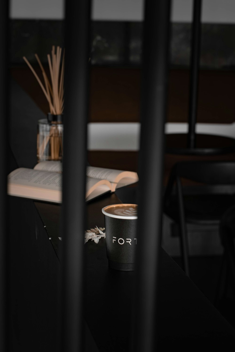 black and silver coffee cup on brown wooden table