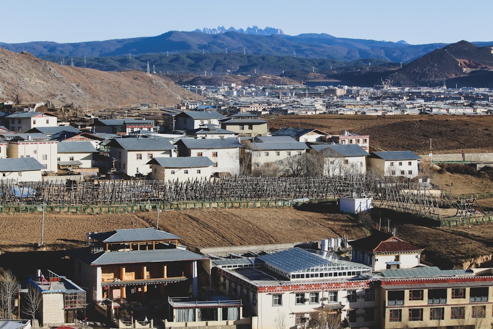 white and brown concrete buildings near mountain during daytime