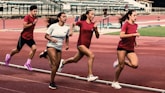 a group of women running on a track