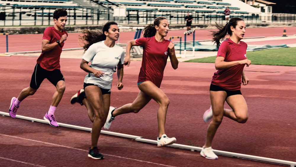 a group of women running on a track