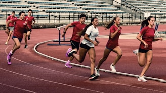 a group of people running on a track