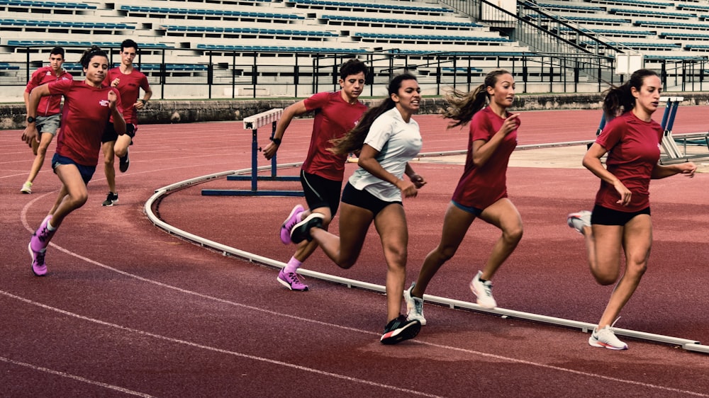 a group of people running on a track