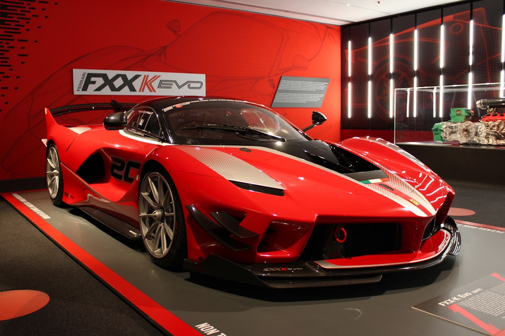 red ferrari sports car parked in front of red and white building