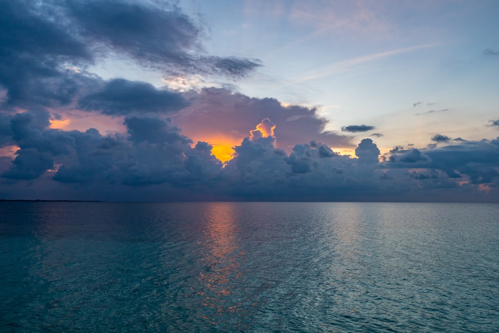 body of water under cloudy sky during daytime