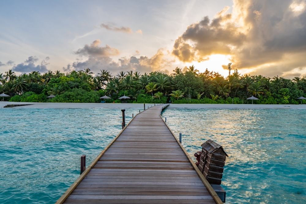 Braunes Holzdock am blauen Meer unter weißen Wolken tagsüber