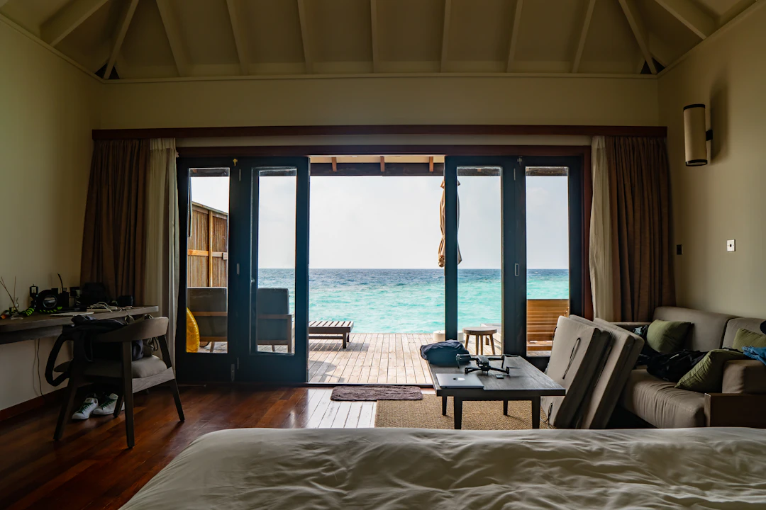wooden table and chairs facing the sea
