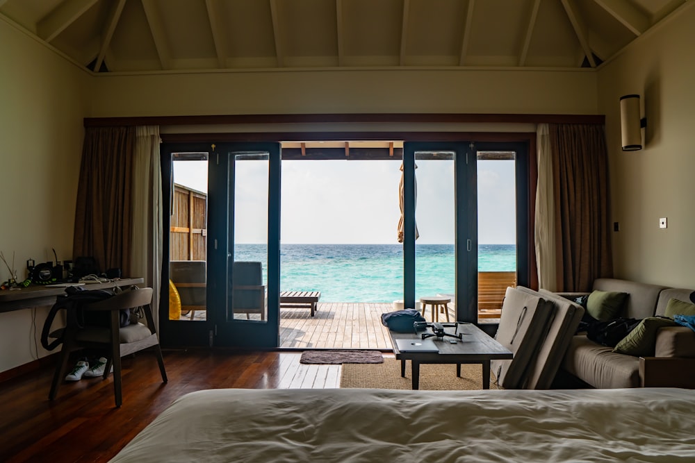 brown wooden table and chairs near sea during daytime