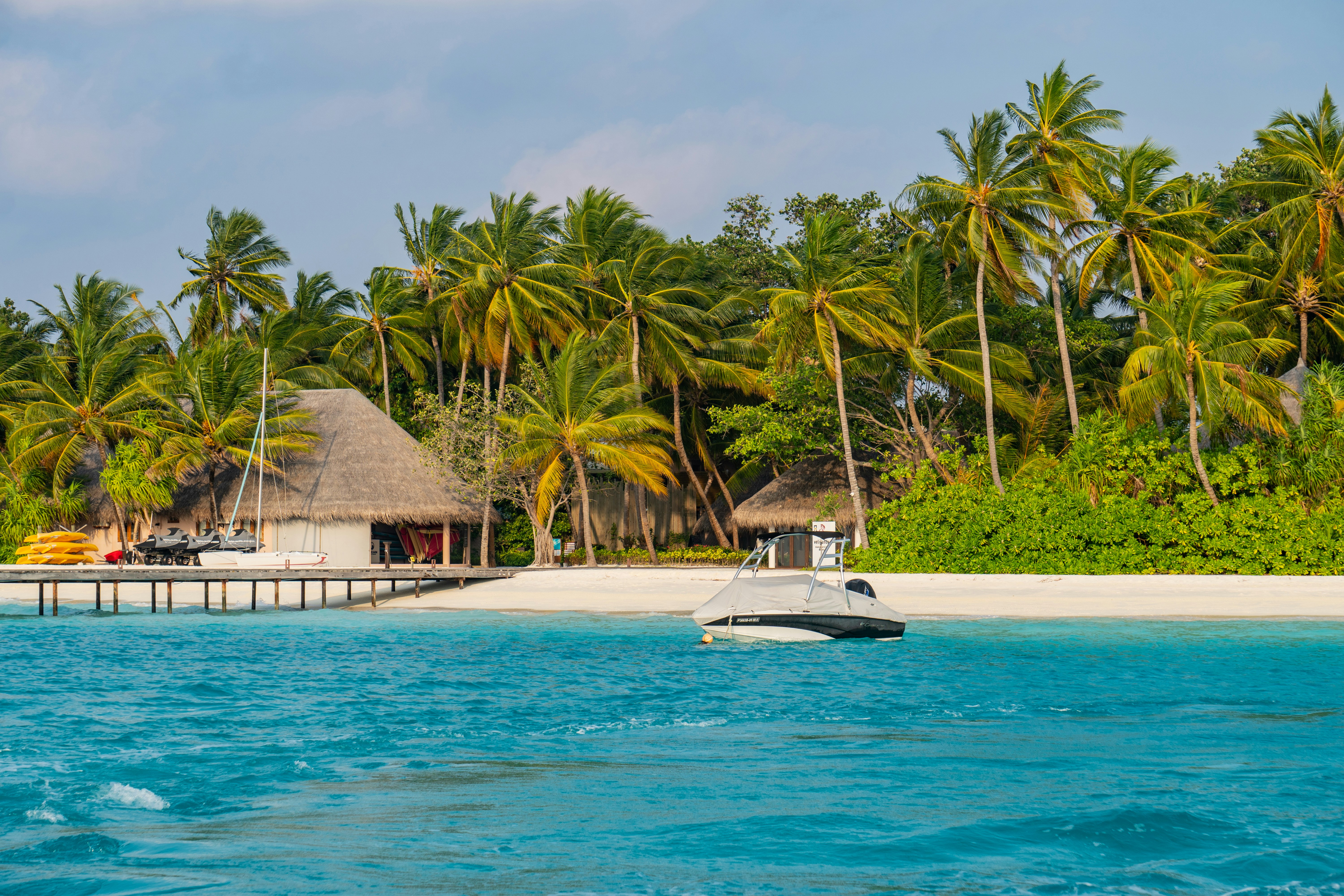 white and brown wooden house near body of water during daytime, 