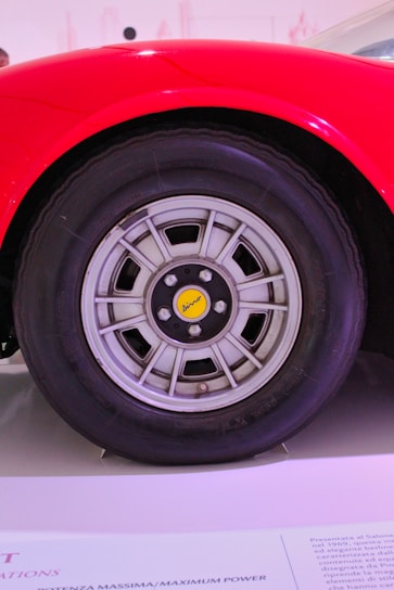 Close-up of a vibrant red PKL centre cap mounted on a sleek Audi wheel.