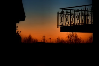 Close-up of a balcony overlooking Pune’s skyline at sunset.