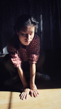 A person doing squats in a cozy living room with natural light.