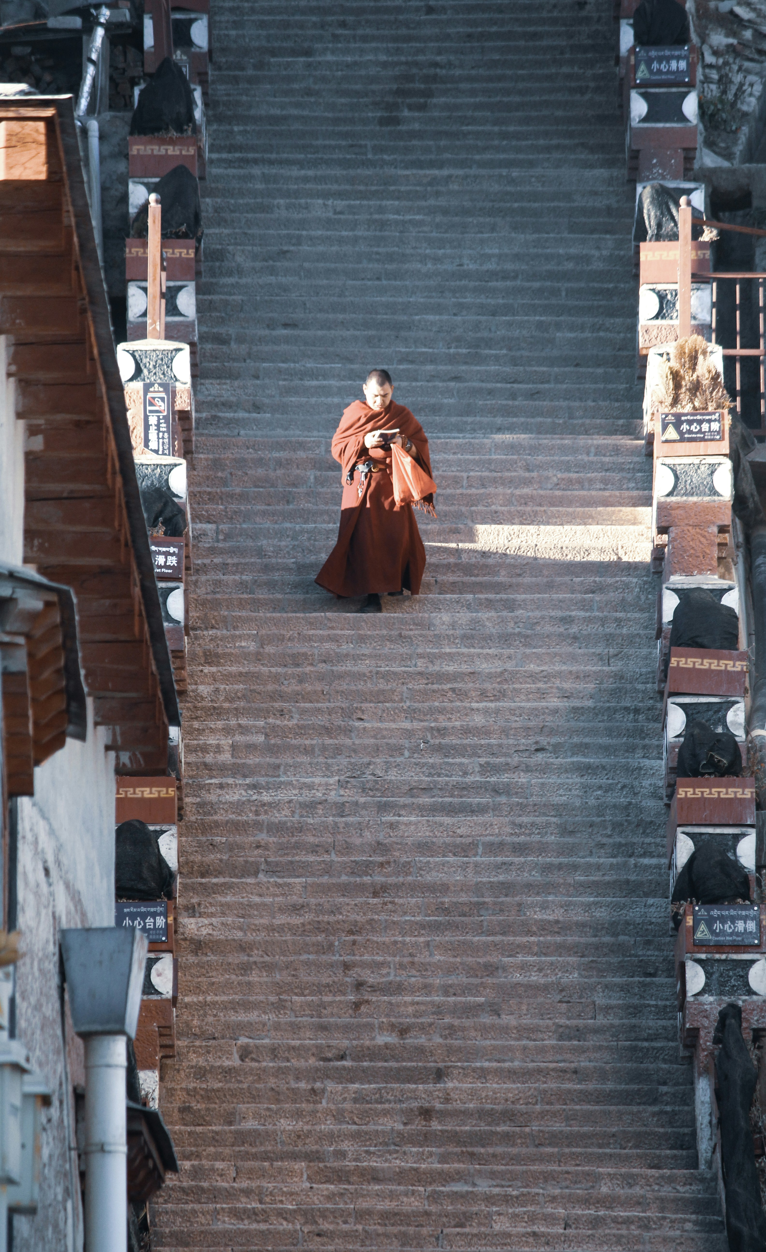 woman in red dress walking on gray concrete stairs