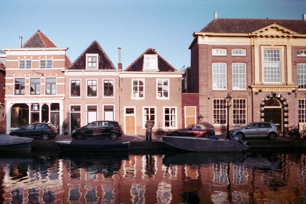 brown and white concrete building beside body of water during daytime