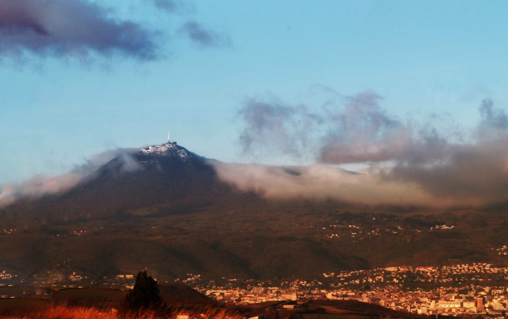 brown mountain under white clouds during daytime