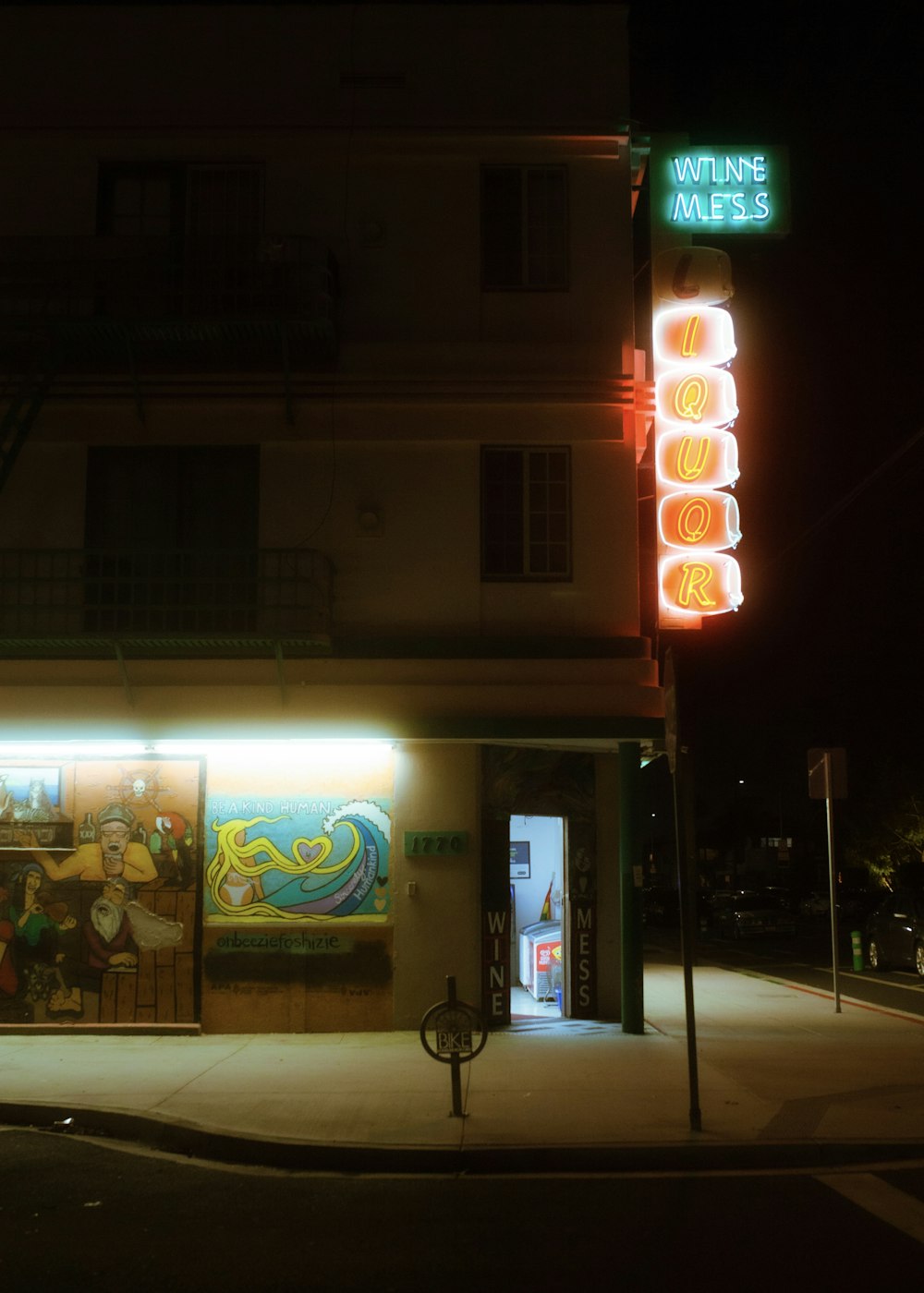 black bicycle parked beside store during night time