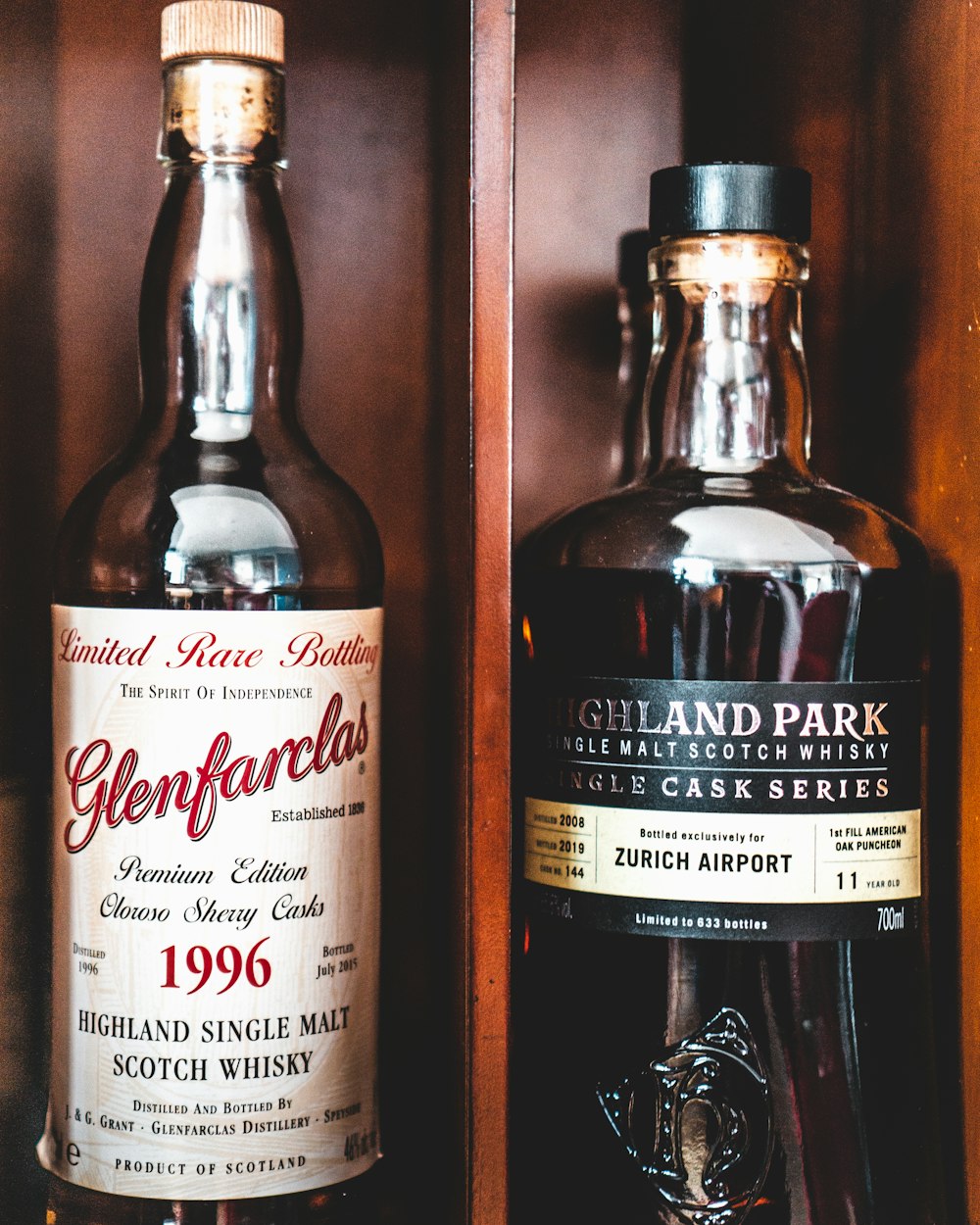 a couple of bottles of alcohol sitting on a shelf