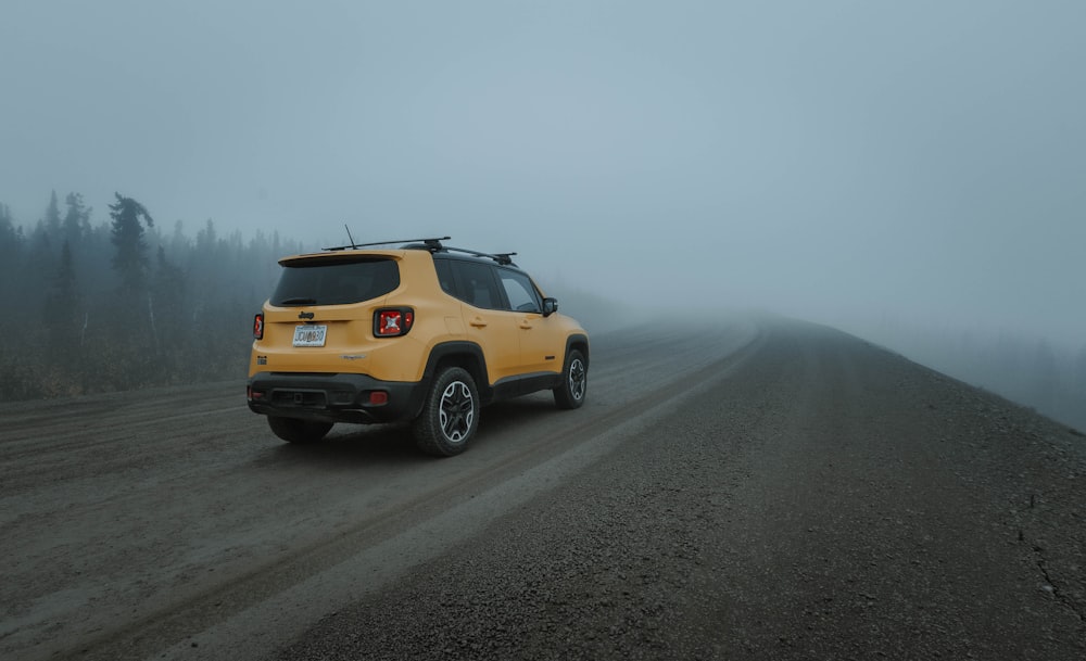 yellow suv on gray asphalt road during daytime