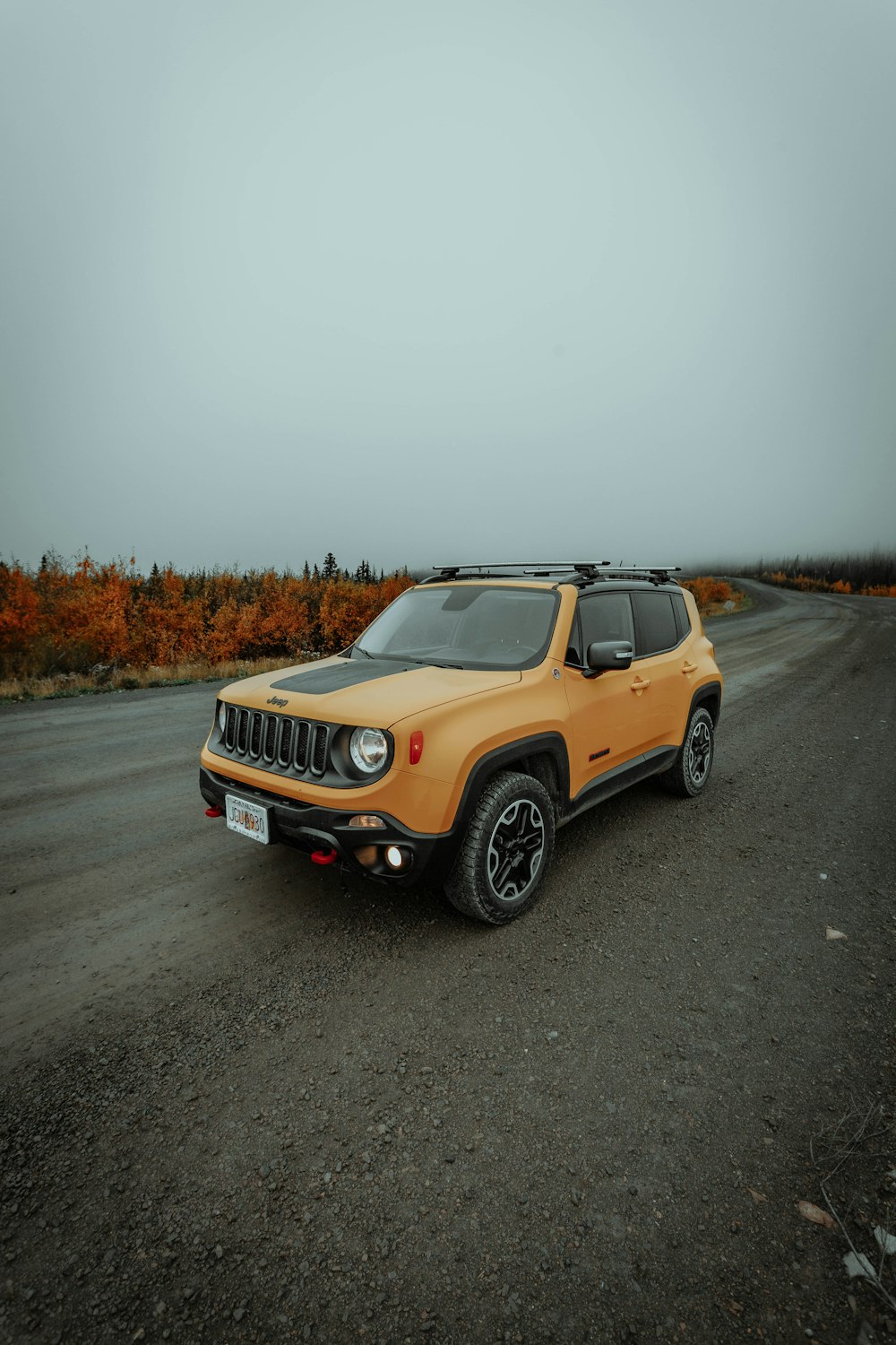 yellow and black jeep grand cherokee on road