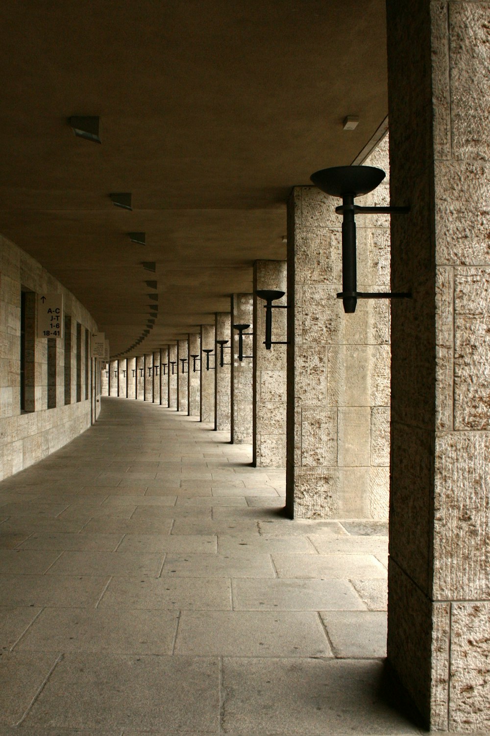 gray concrete hallway with light fixture