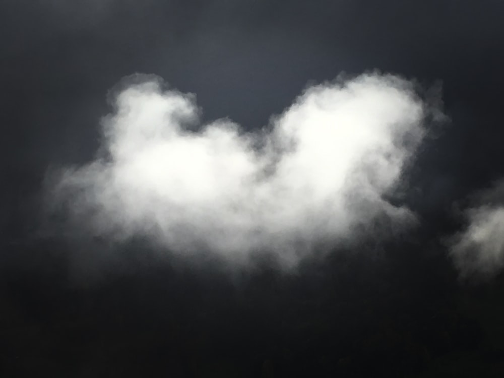 white clouds on black sky