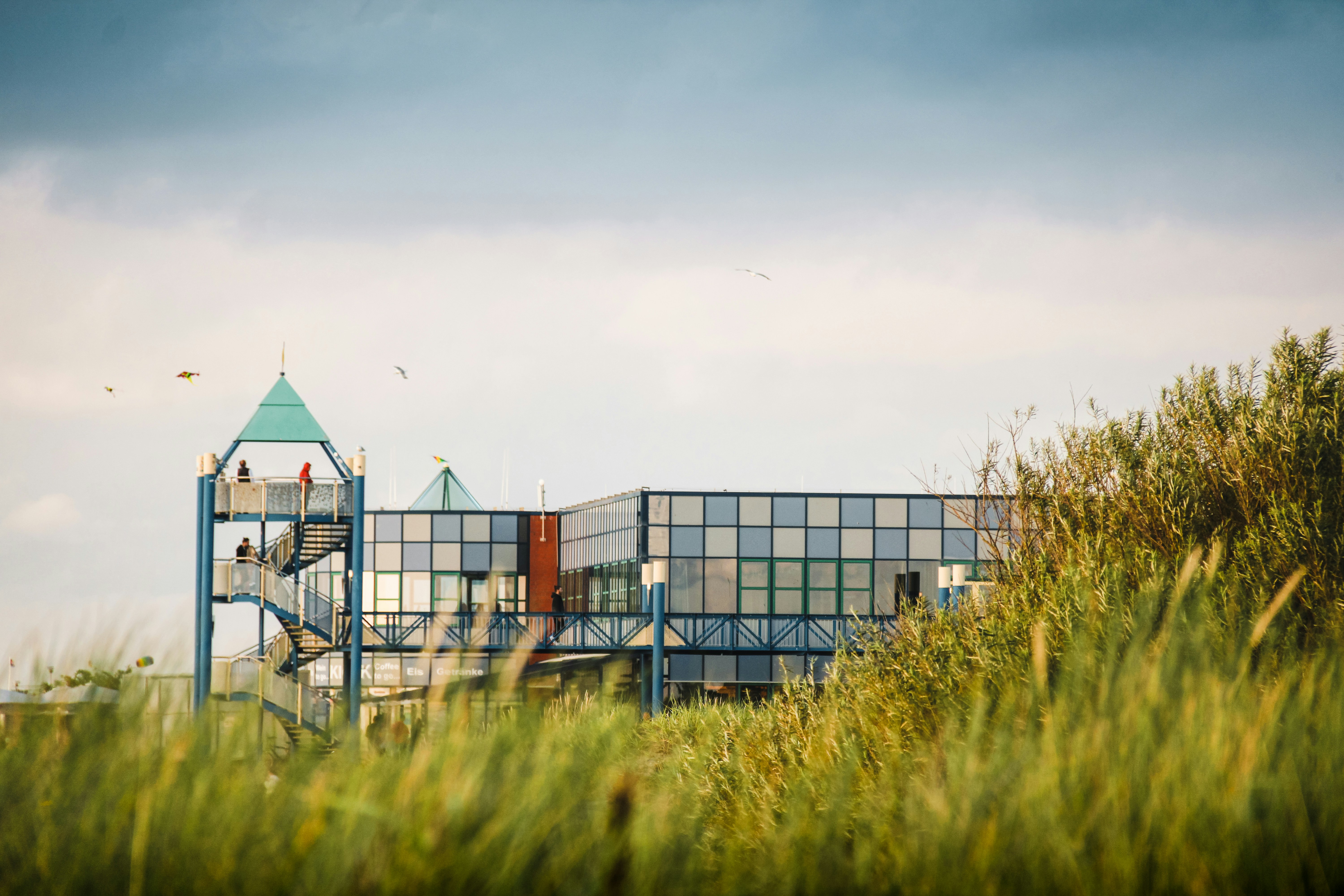 white and brown building near green grass field during daytime