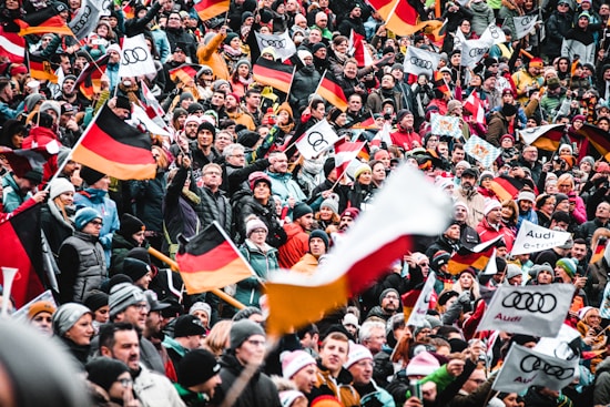 a large crowd of people holding flags and banners