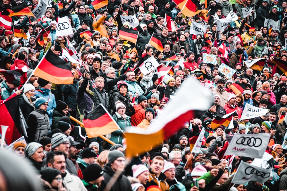 a large crowd of people holding flags and banners