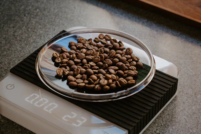 brown coffee beans on clear glass bowl