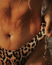 woman in black and white leopard print brassiere