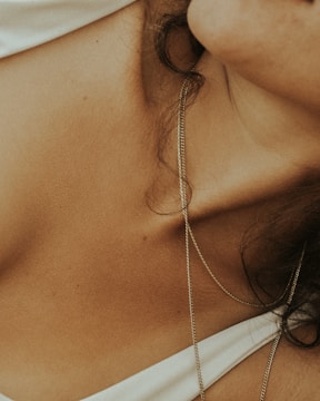Close-up of a collarbone illuminated by soft, dramatic lighting with deep shadows.