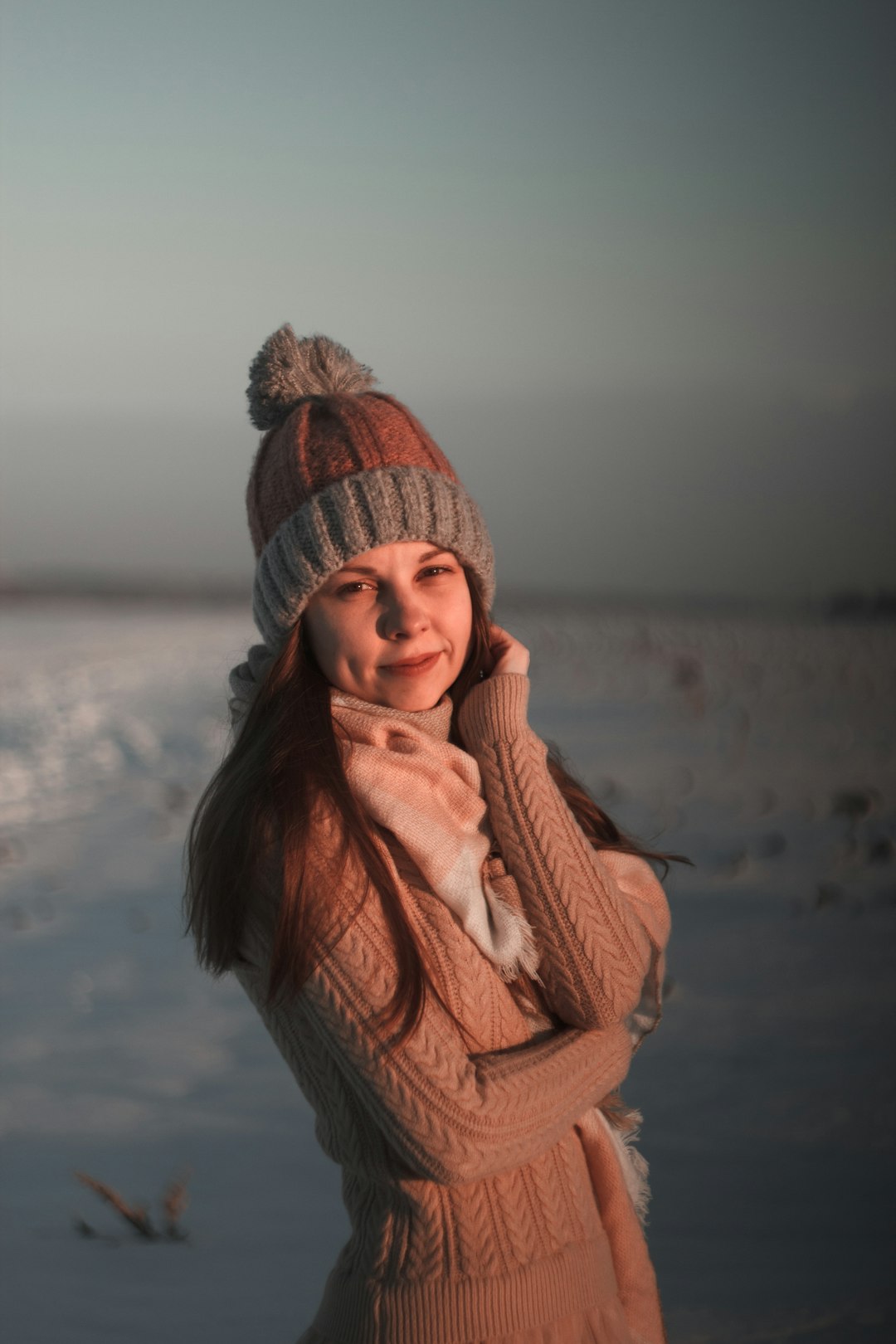 woman in brown scarf and white knit cap