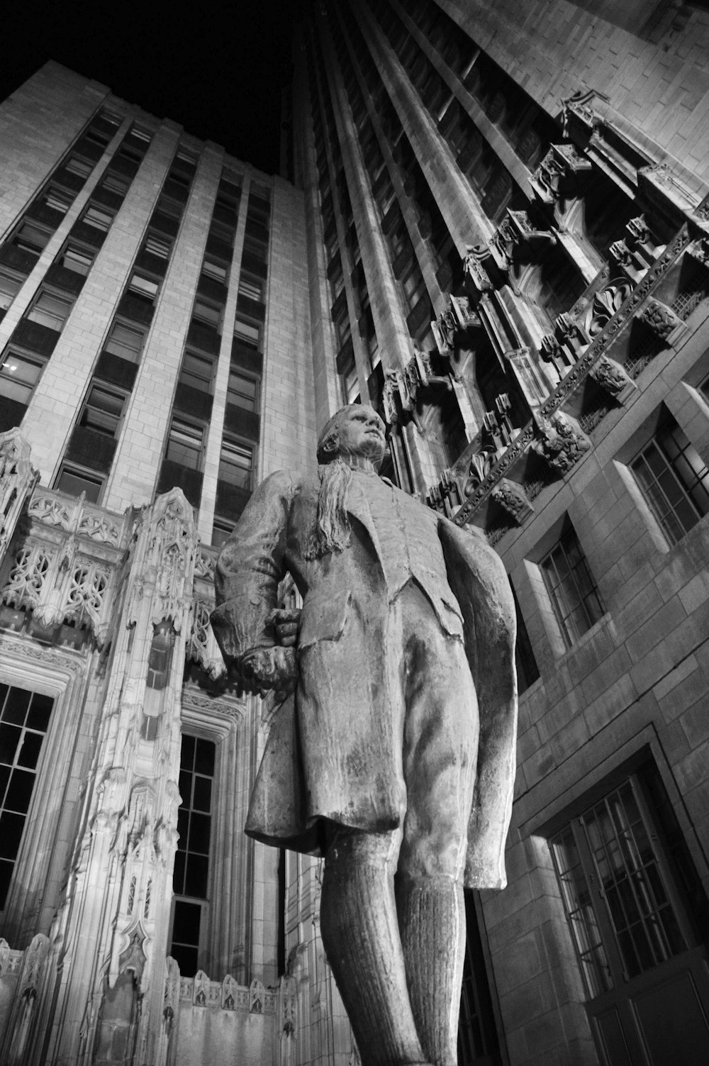 grayscale photo of man and woman statue