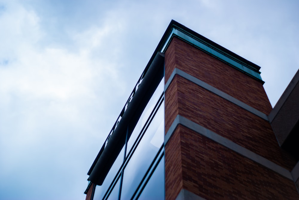 brown and black concrete building under white clouds during daytime