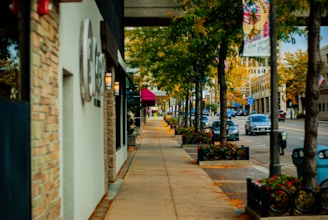 A vibrant city street in Vigneux-sur-Seine with clean sidewalks and green trees.