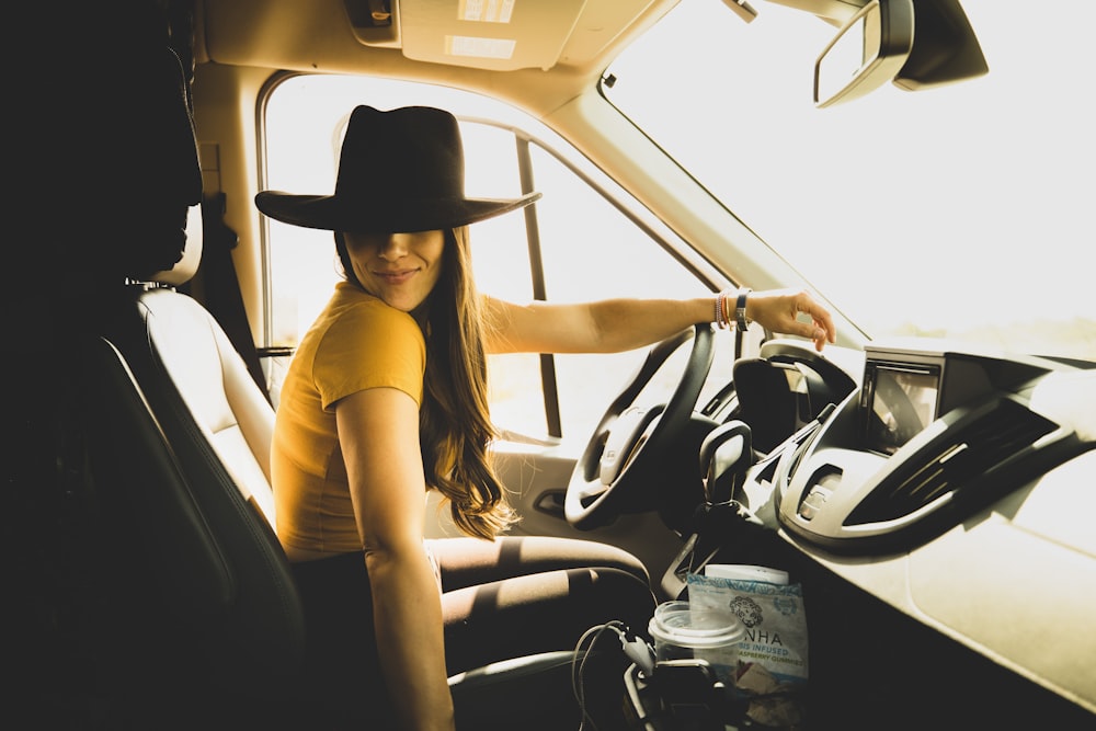 woman in yellow shirt driving car