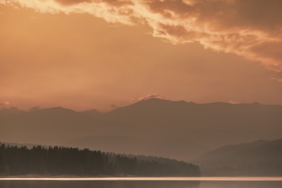 A serene landscape of California mountains framed in gold.