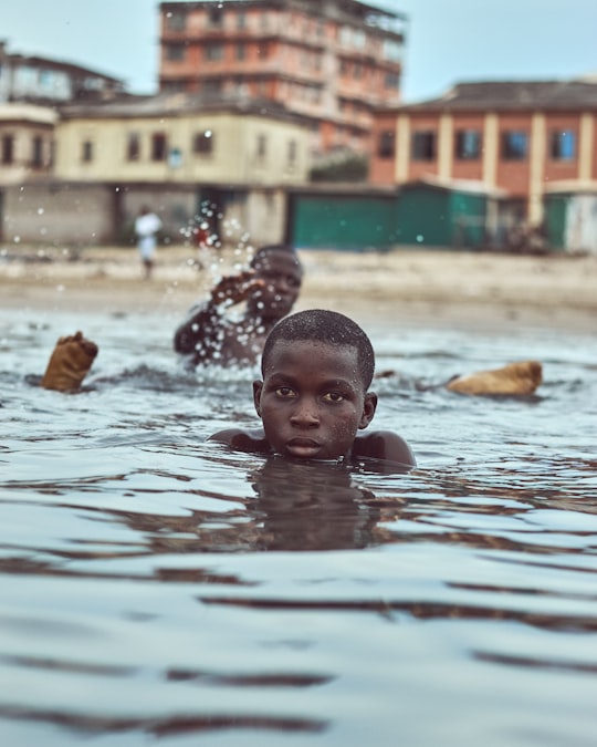 baby in water during daytime in Takoradi Ghana