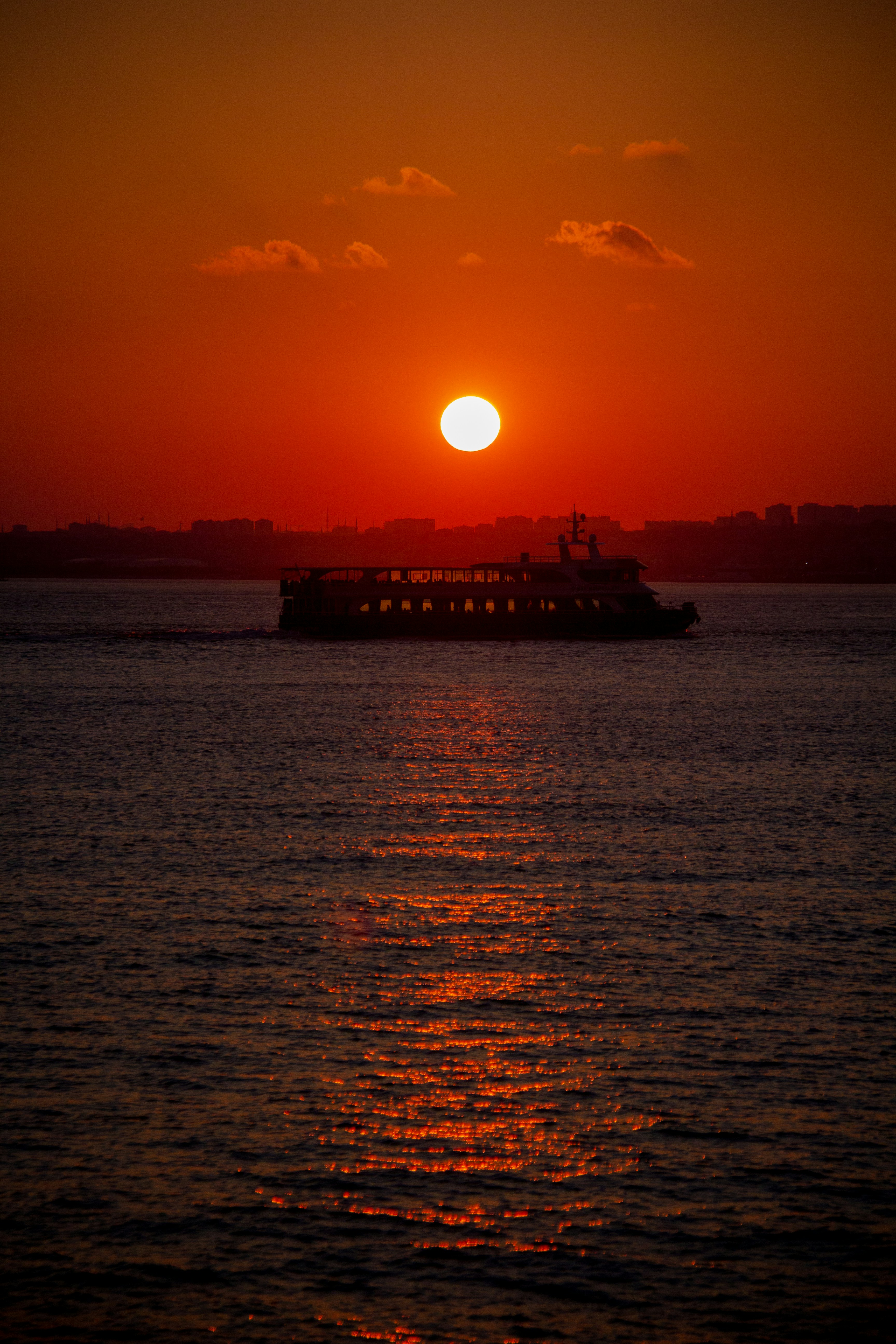 silhouette of ship on sea during sunset