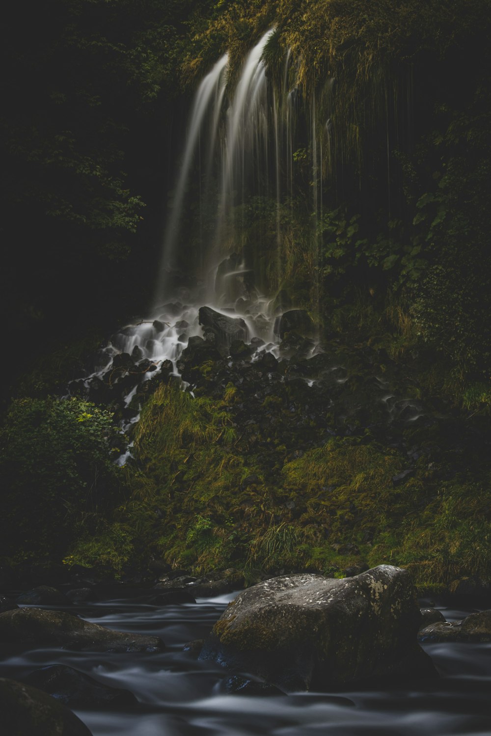 water falls on black rock